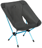 A lightweight Helinox camping chair with a gray patterned fabric seat and a blue frame on a white background.