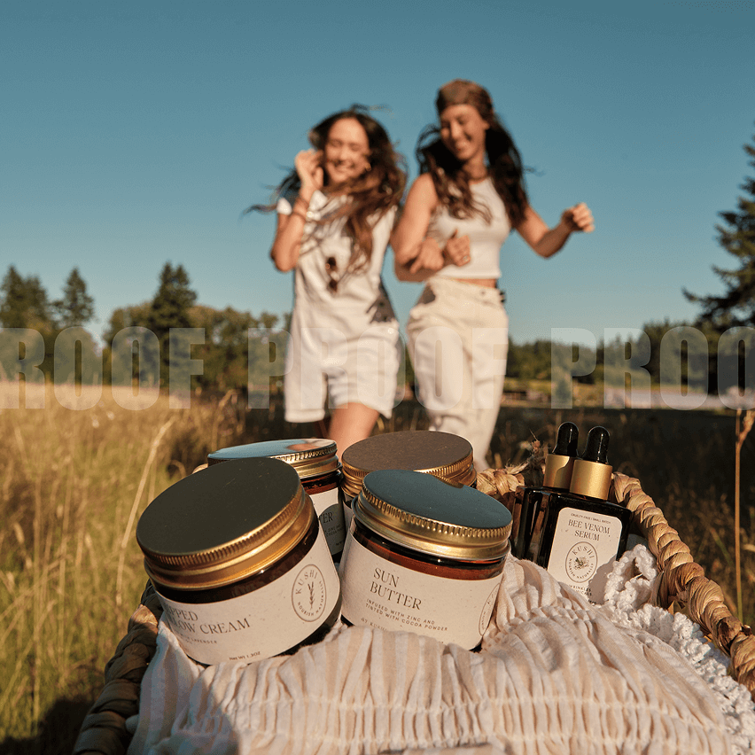 Basket with skincare products, two women smiling in background in a field.