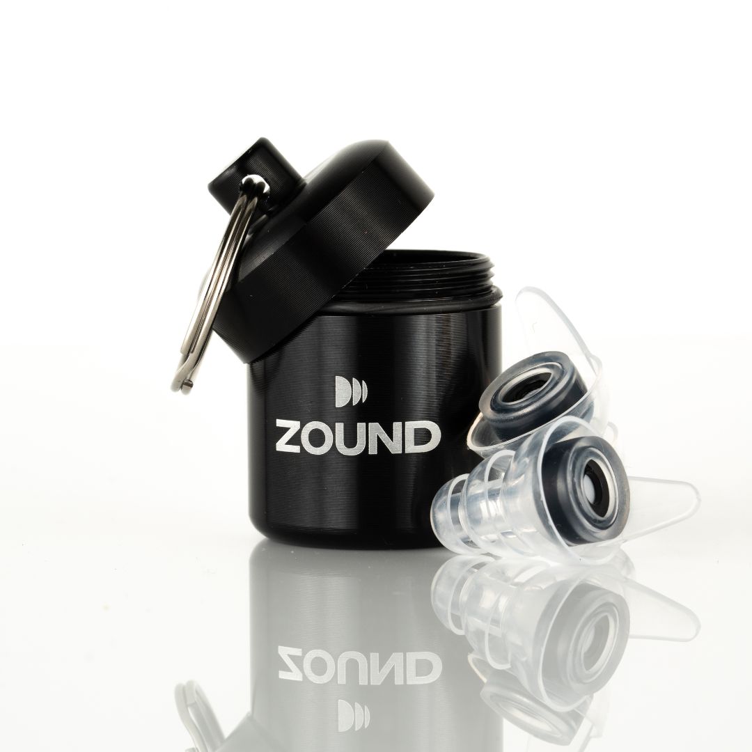 Black container labeled 'Zound' with transparent earplugs beside it.