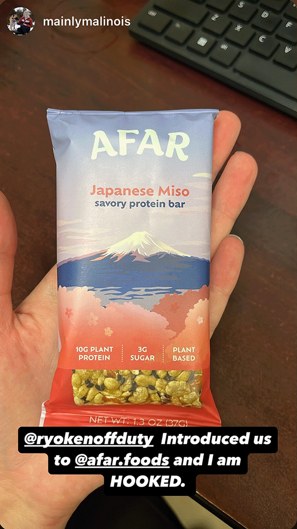 Afar savory protein bar in hand