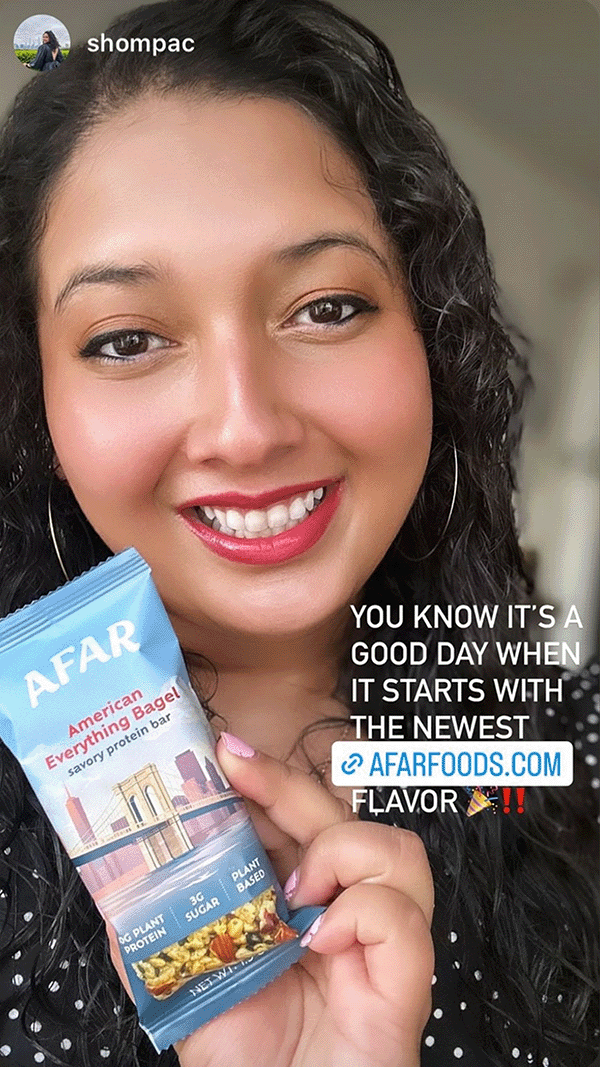 Woman holding Afar savory protein bar