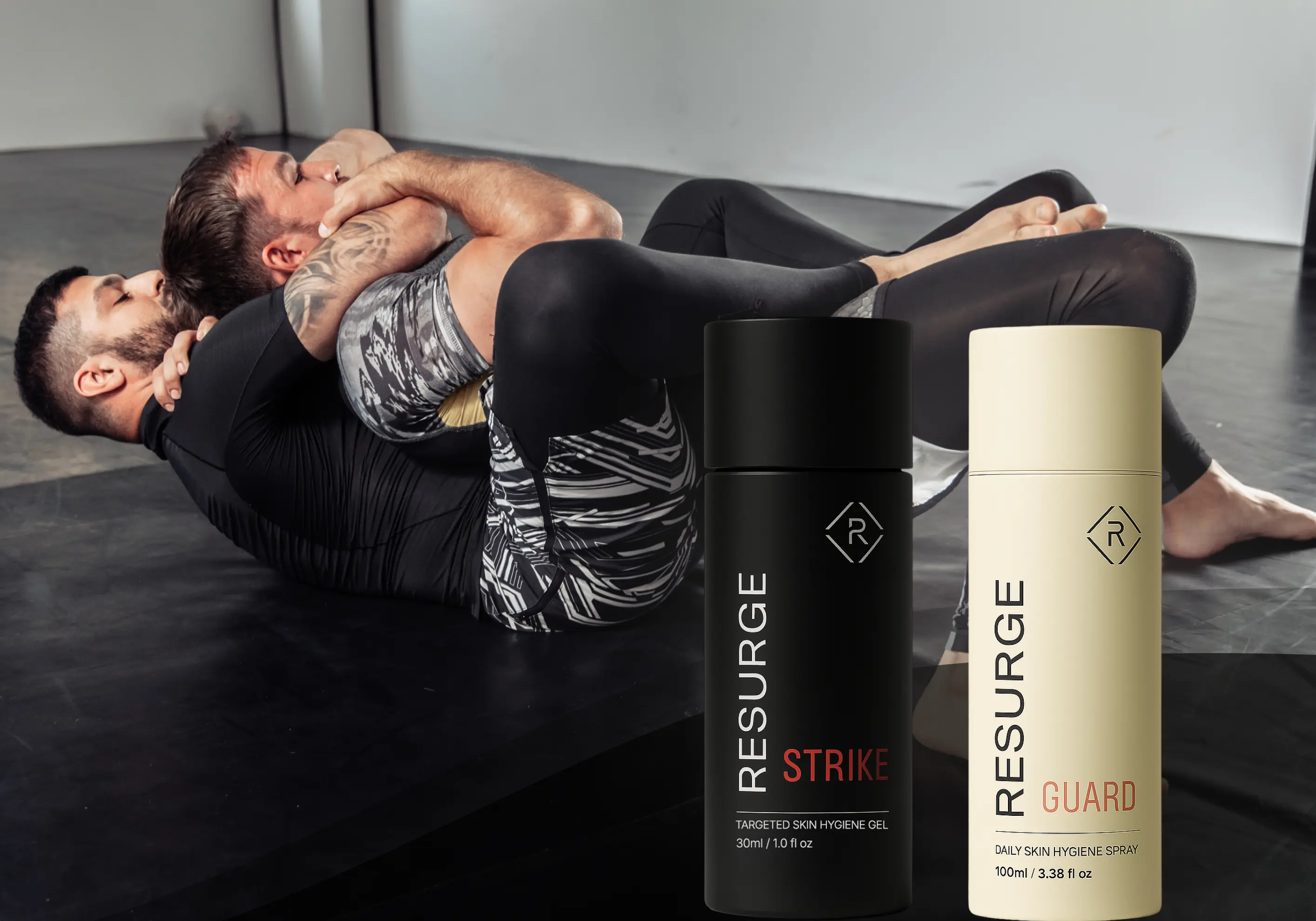 Two men practicing grappling on a mat with skincare products in the foreground.