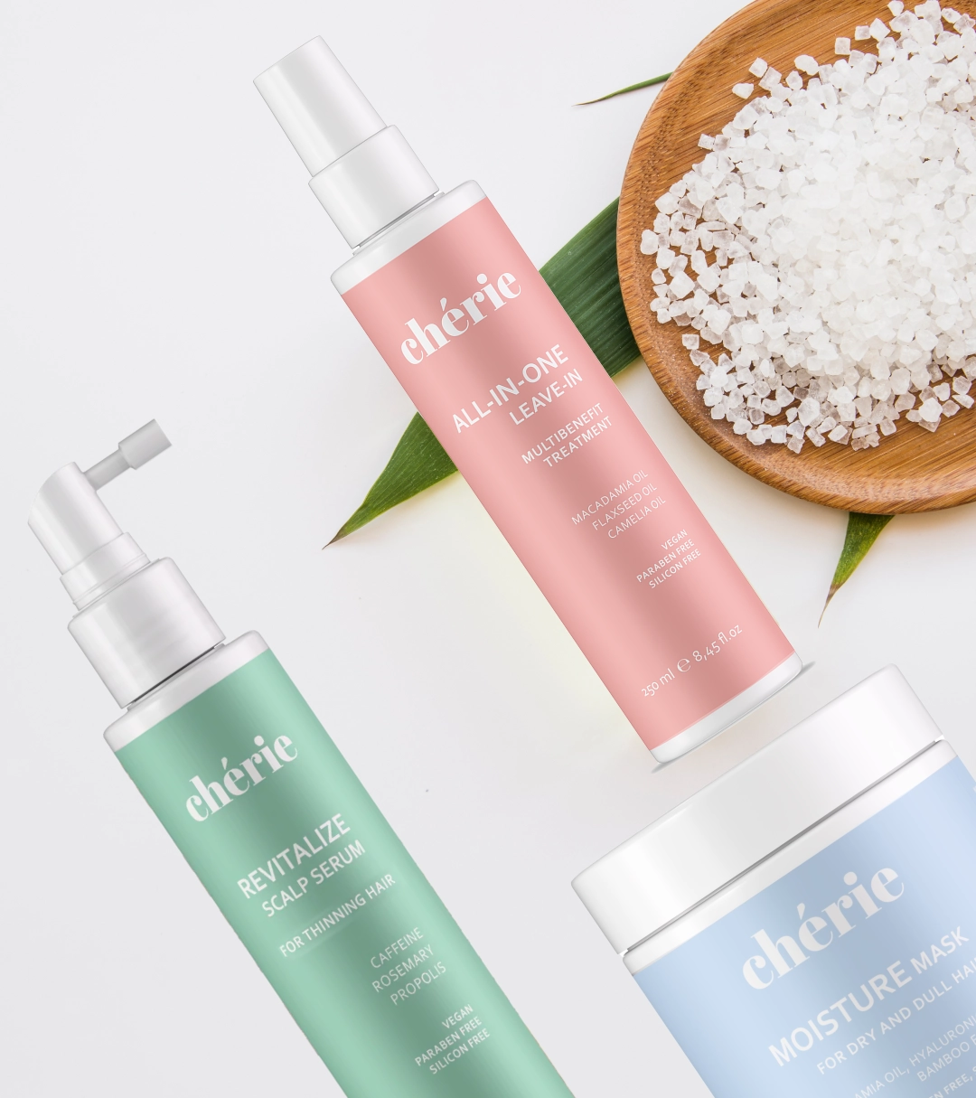 Three Cherie haircare products with a bowl of white crystals.