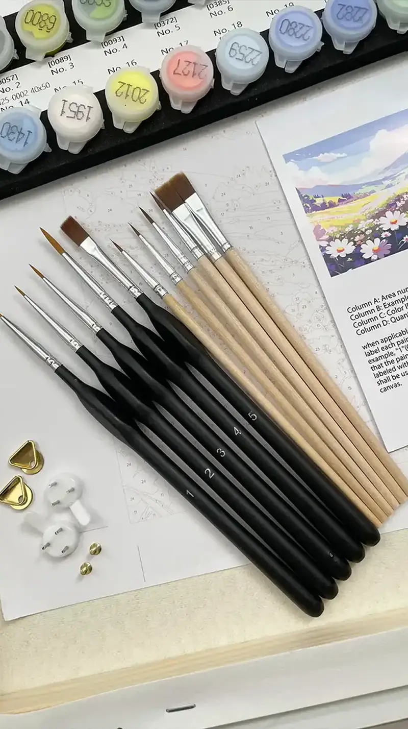 A paint-by-numbers kit with numbered paint pots, various brushes, and a reference picture of a landscape.