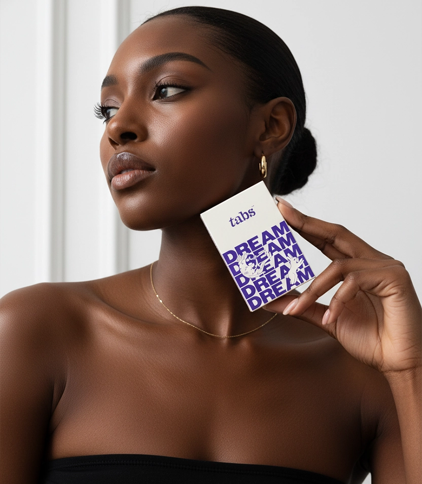 Person holding a card with 'DREAM' text in purple.