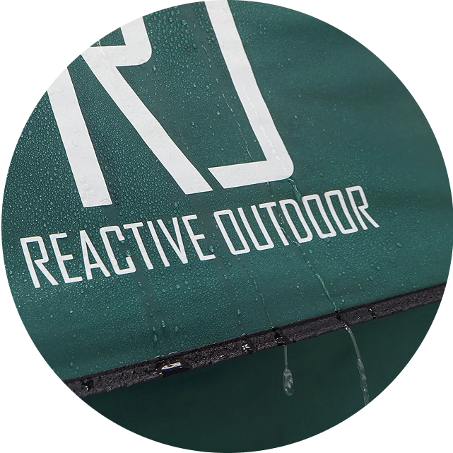 Close-up of a green surface with 'Reactive Outdoor' text and water droplets.