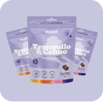 Three purple pouches of Buddy brand 'Tranquilo & Calmo' pet treats against a purple background.