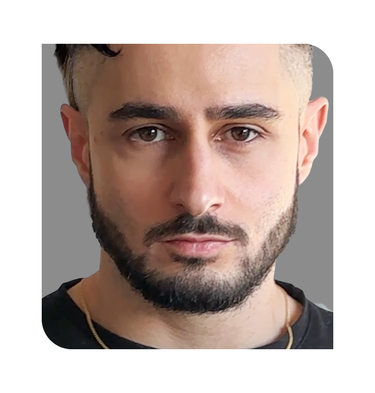 Man with short hair and beard against a gray background.