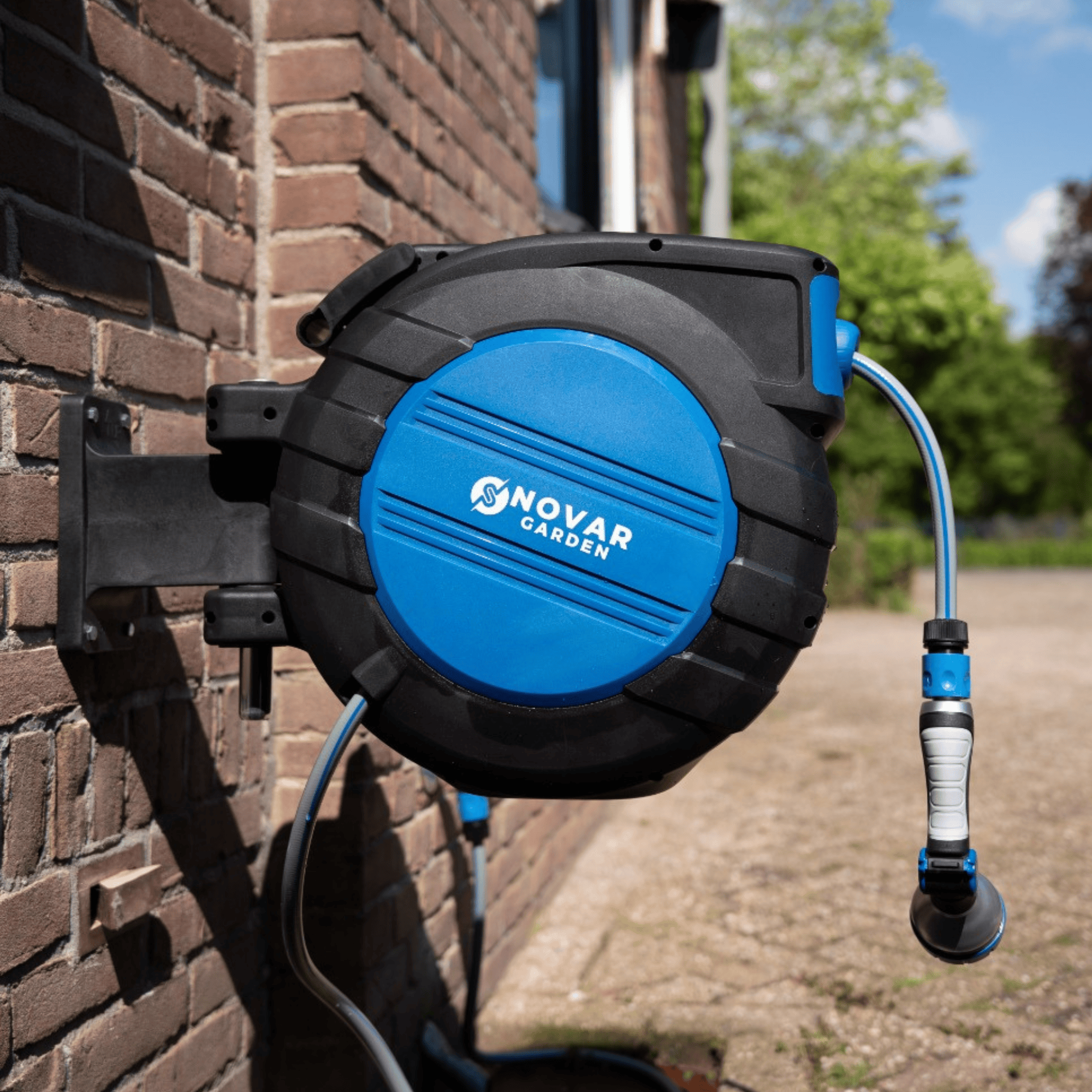 Wall-mounted blue garden hose reel with a nozzle, labeled 'Novar Garden.'