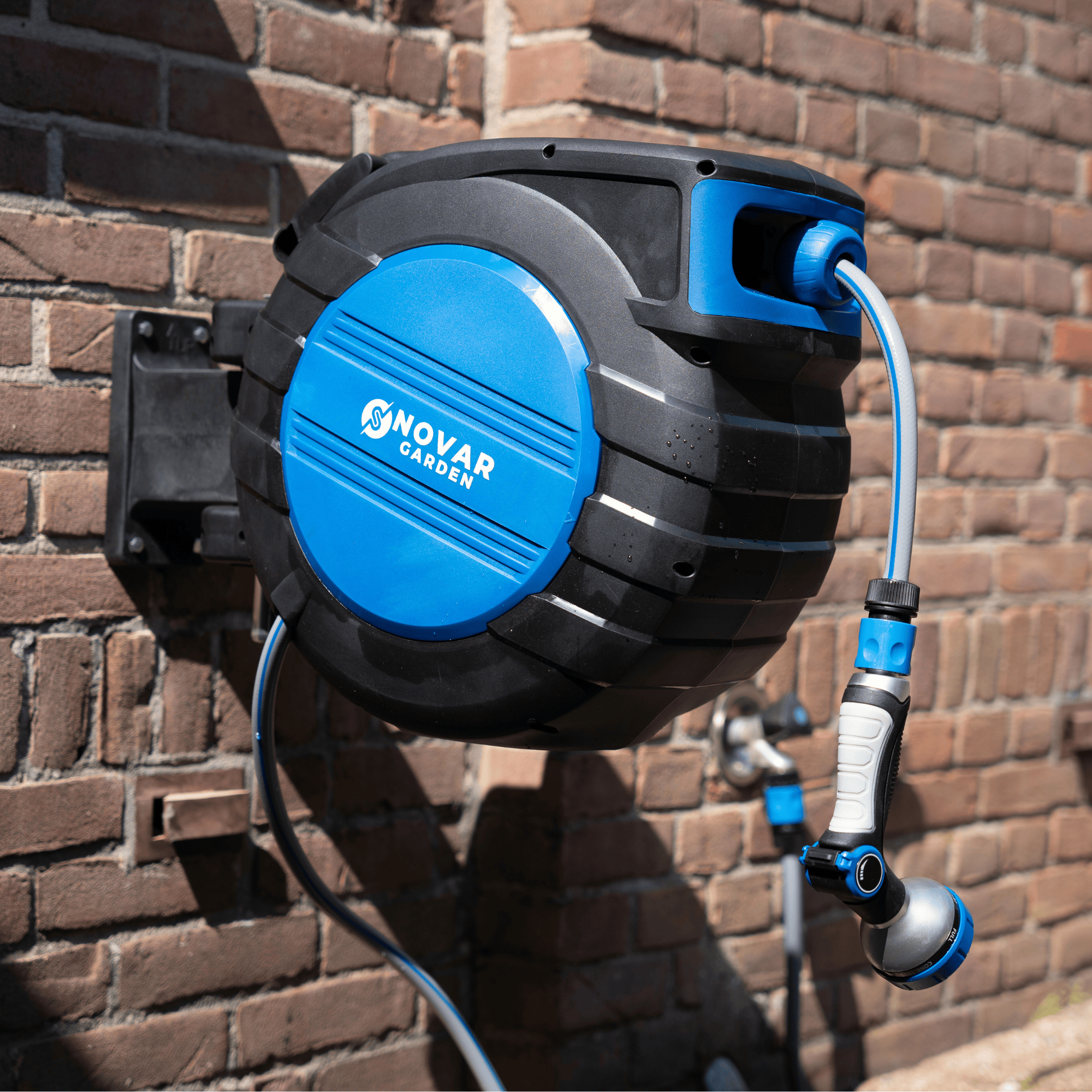 Wall-mounted garden hose reel with blue and black design.