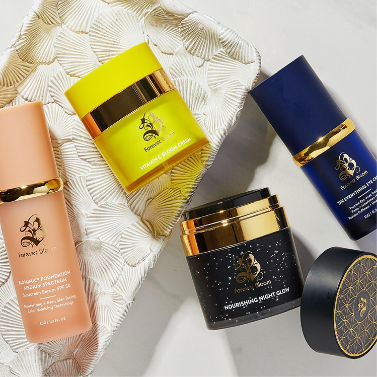 A collection of colorful Forever Bloom skincare products displayed on a decorative white tray.