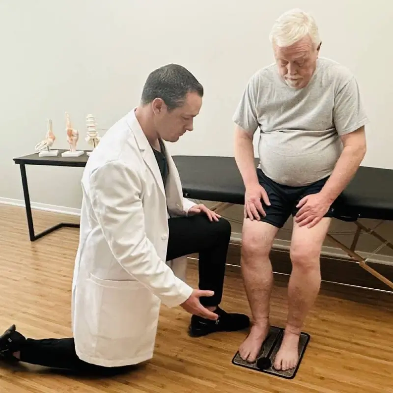Person in white coat using a clear facial tool on chin.
