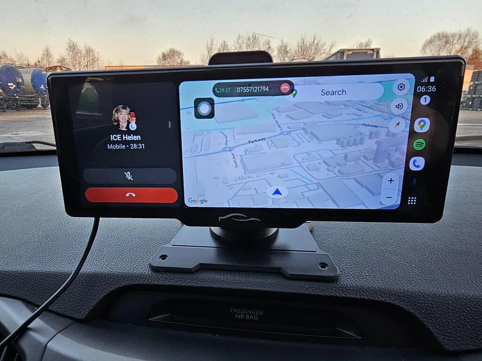 Car dashboard display shows a call with navigation map.