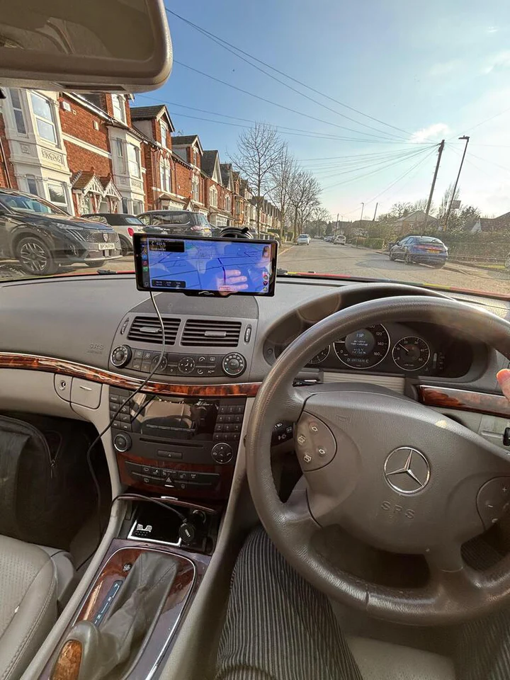 View from inside a car with a navigation screen.