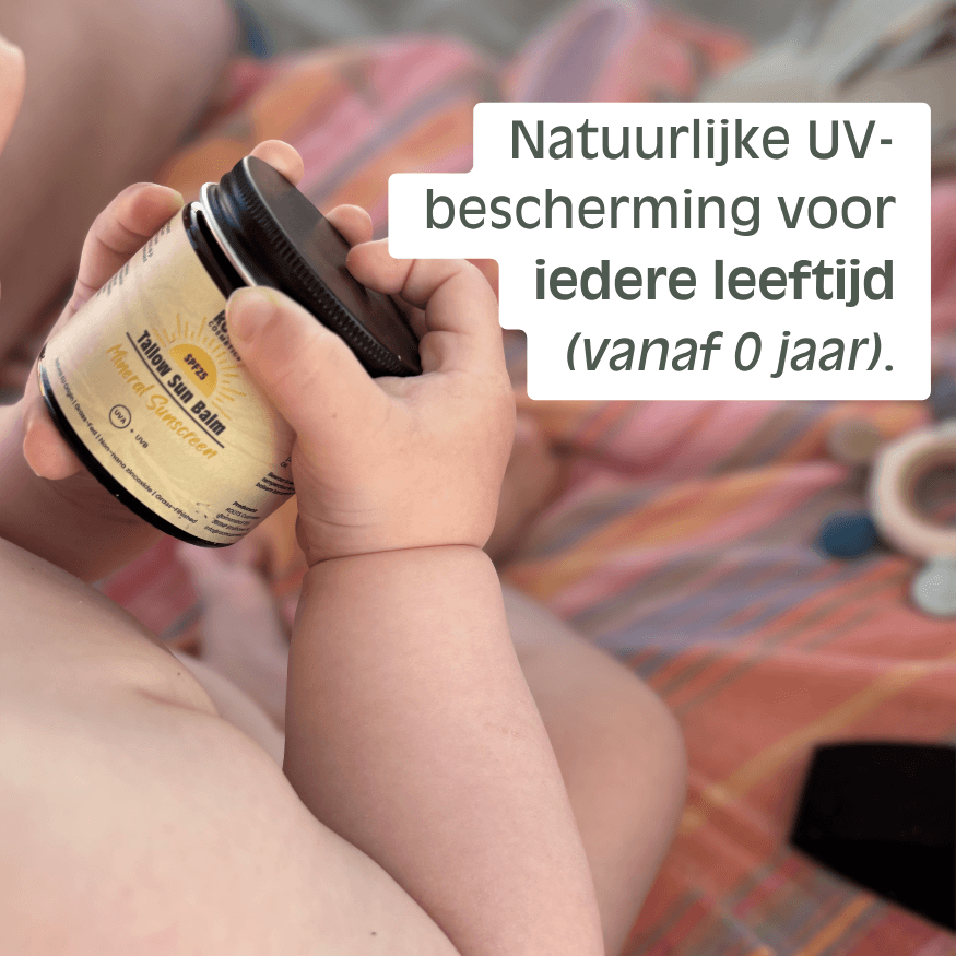 A baby's hands hold a jar of Tallow Sun Balm Mineral Sunscreen against a colorful background.
