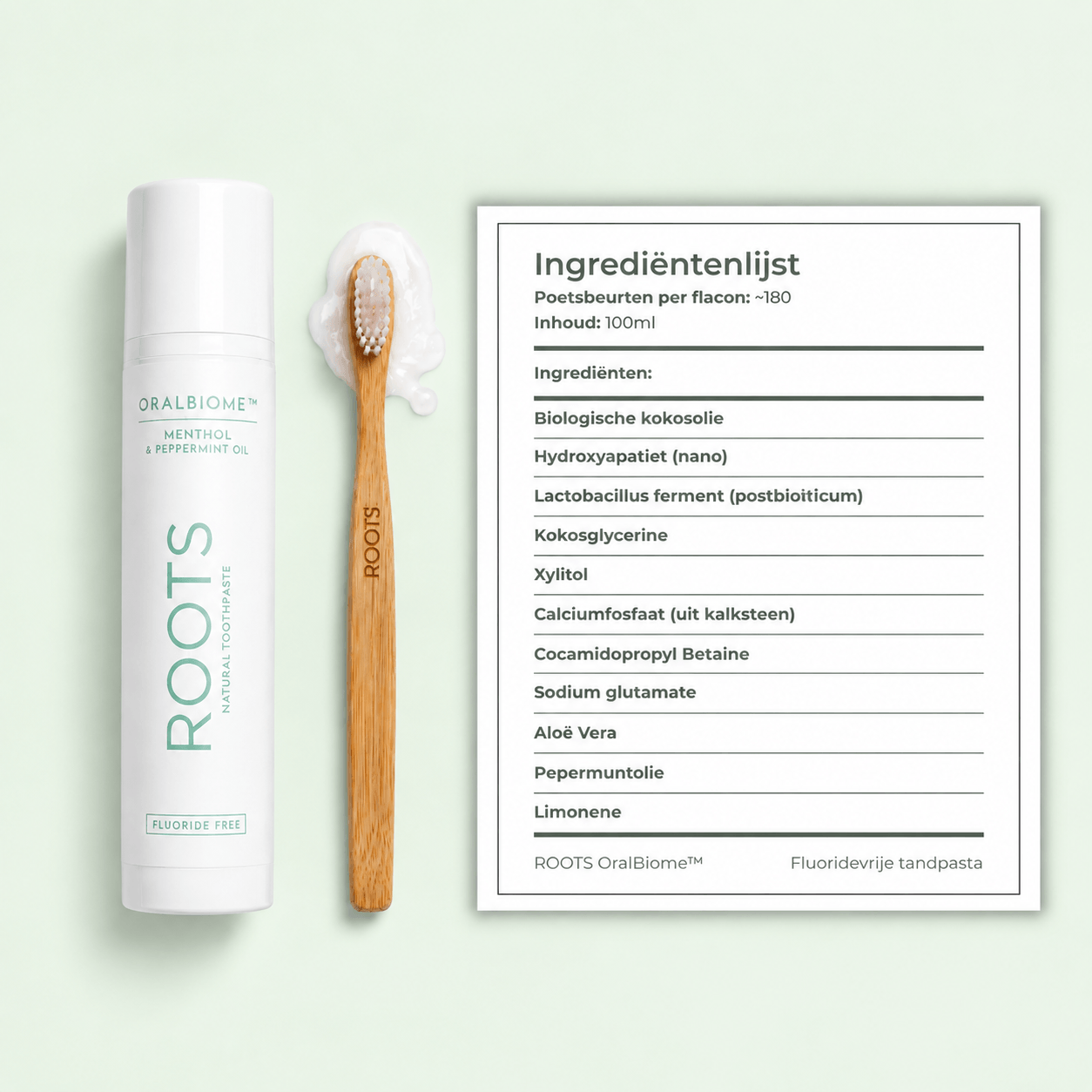 A tube of Roots toothpaste and a wooden toothbrush next to an ingredients list on a green background.