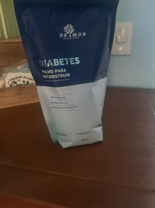 Pack of diabetes powder supplement on a wooden surface.