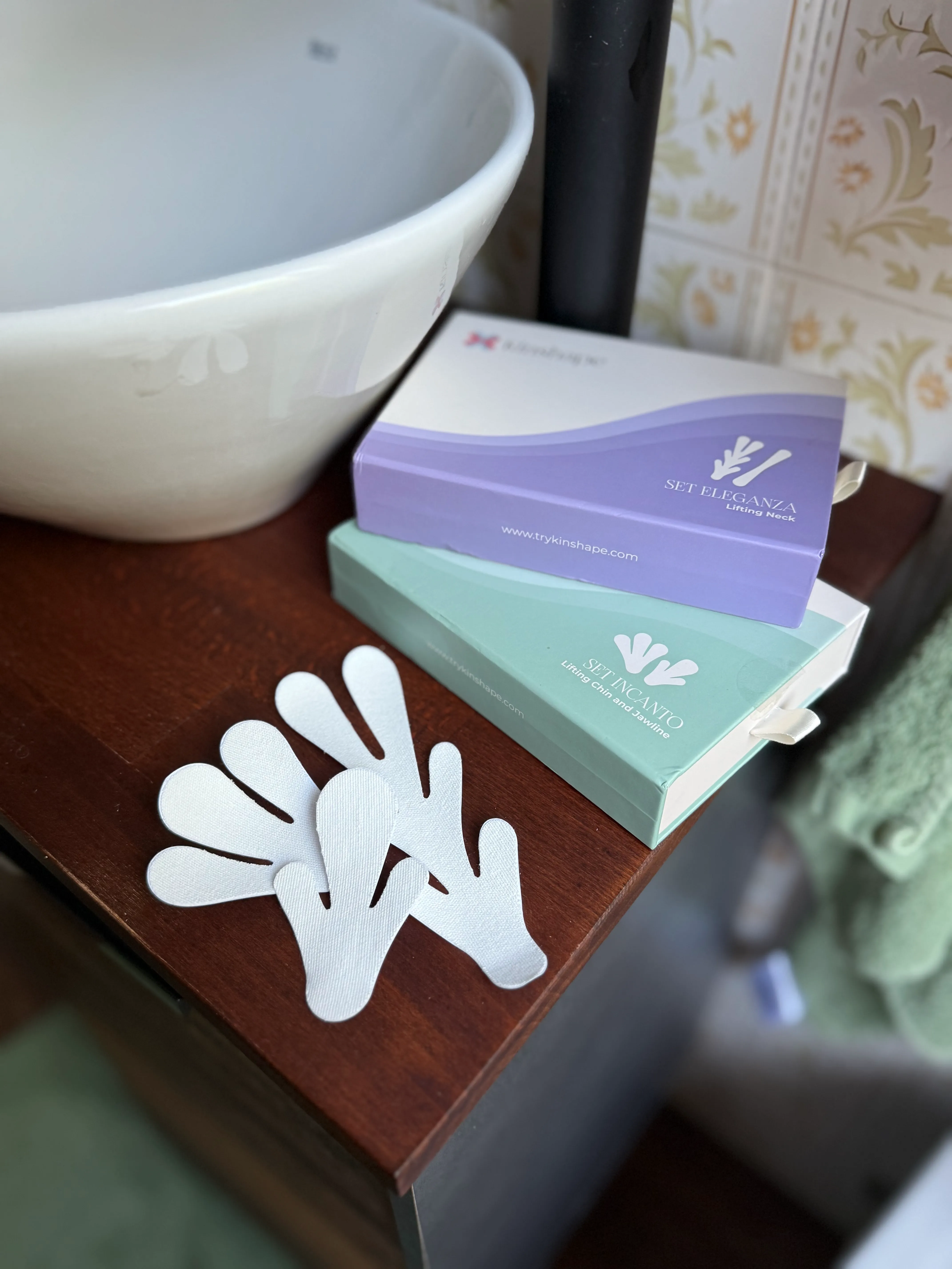 Two boxes of beauty lifting tapes and several white patches on a wooden surface near a sink.