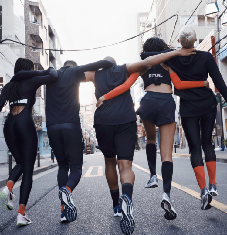 Five people jogging together in an urban area.