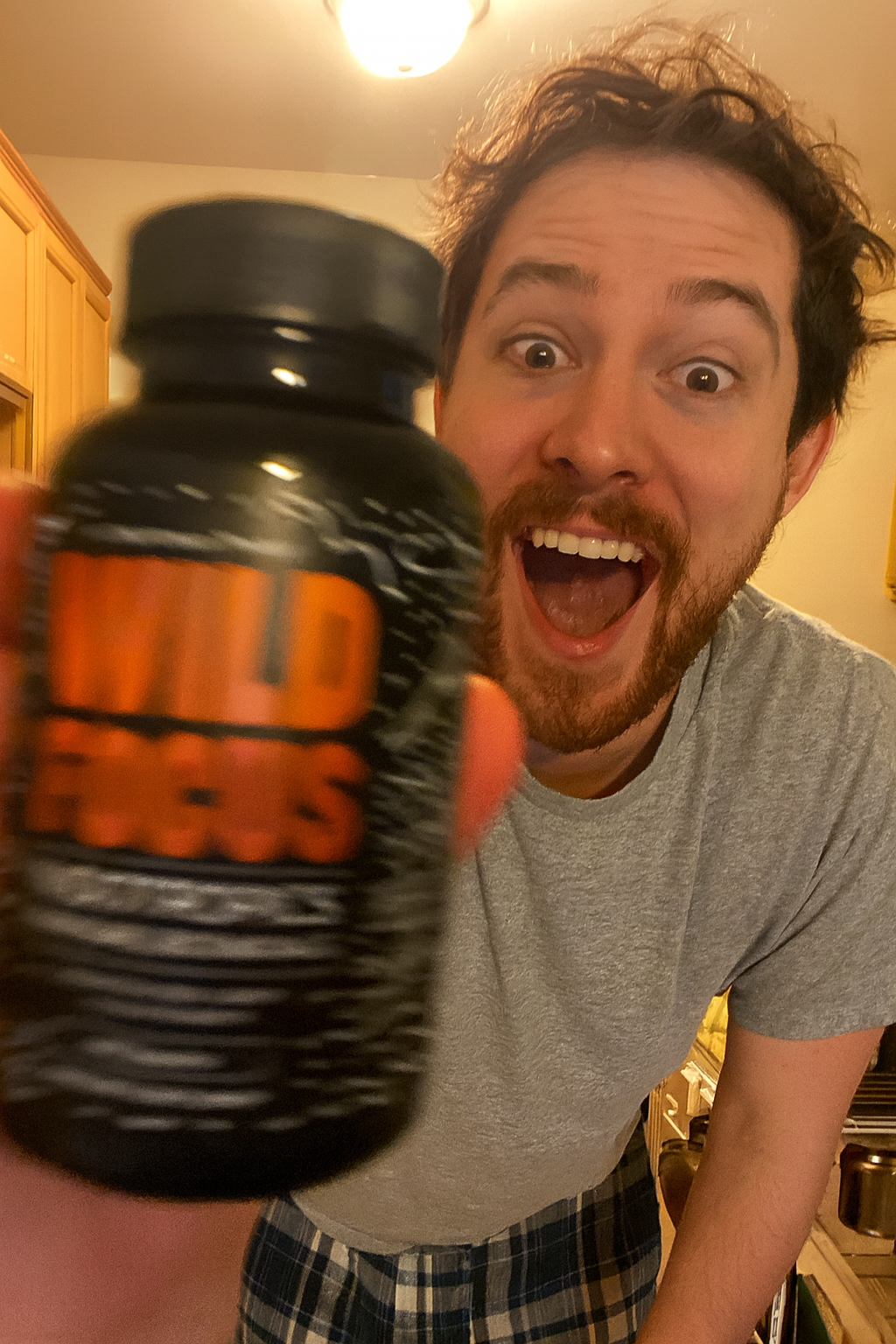 Person holding a bottle labeled 'Wild Focus' with an excited expression.