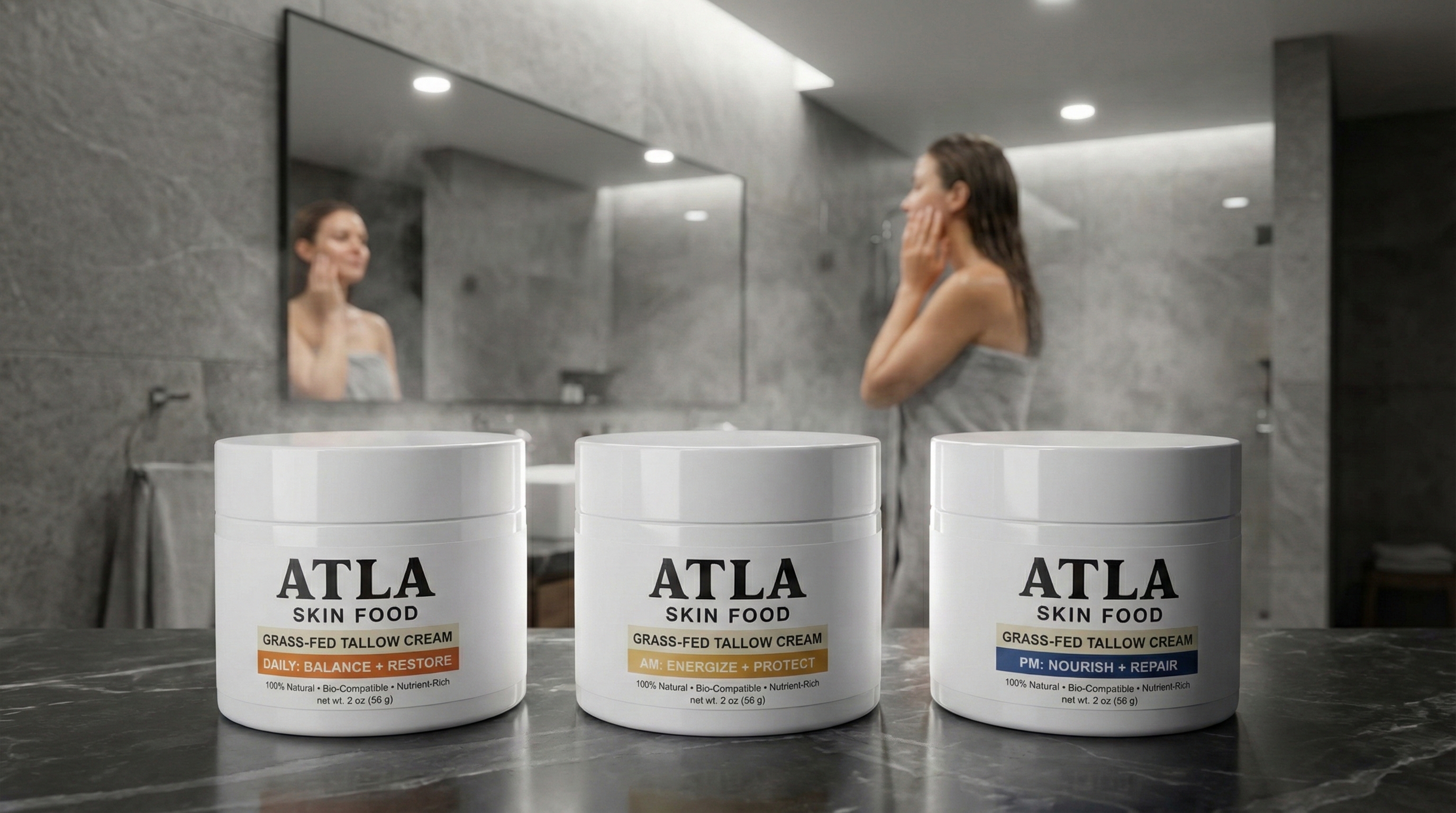 Three jars of Atla Skin Food on a bathroom counter with a woman applying cream in the background.