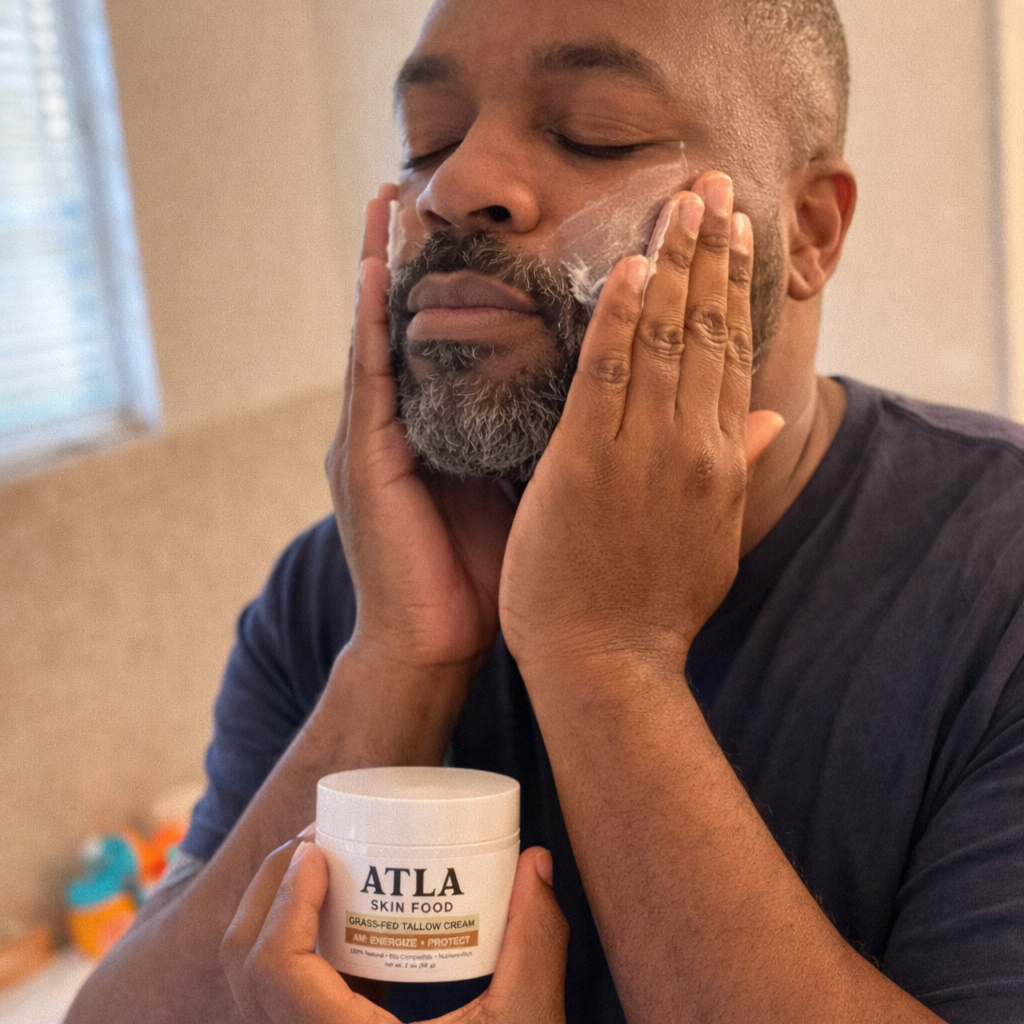 Person applying face cream from a jar labeled 'ATLA Skin Food'.