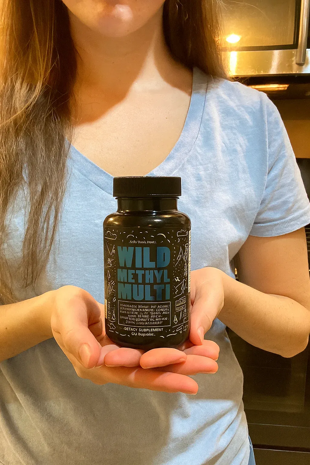 Person holding a bottle labeled 'Wild Methyl Multi' in both hands.