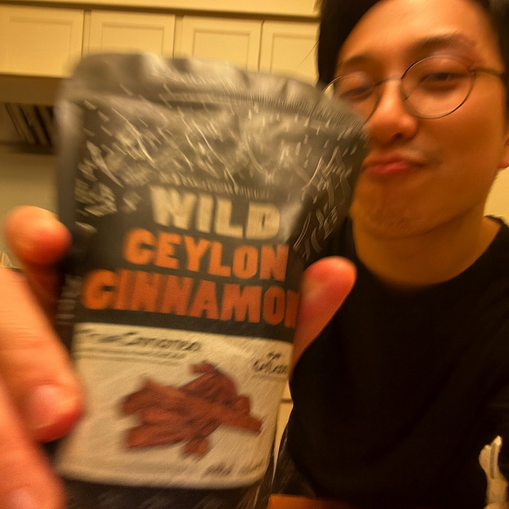 Person holding a packet labeled 'Wild Ceylon Cinnamon' in a kitchen.