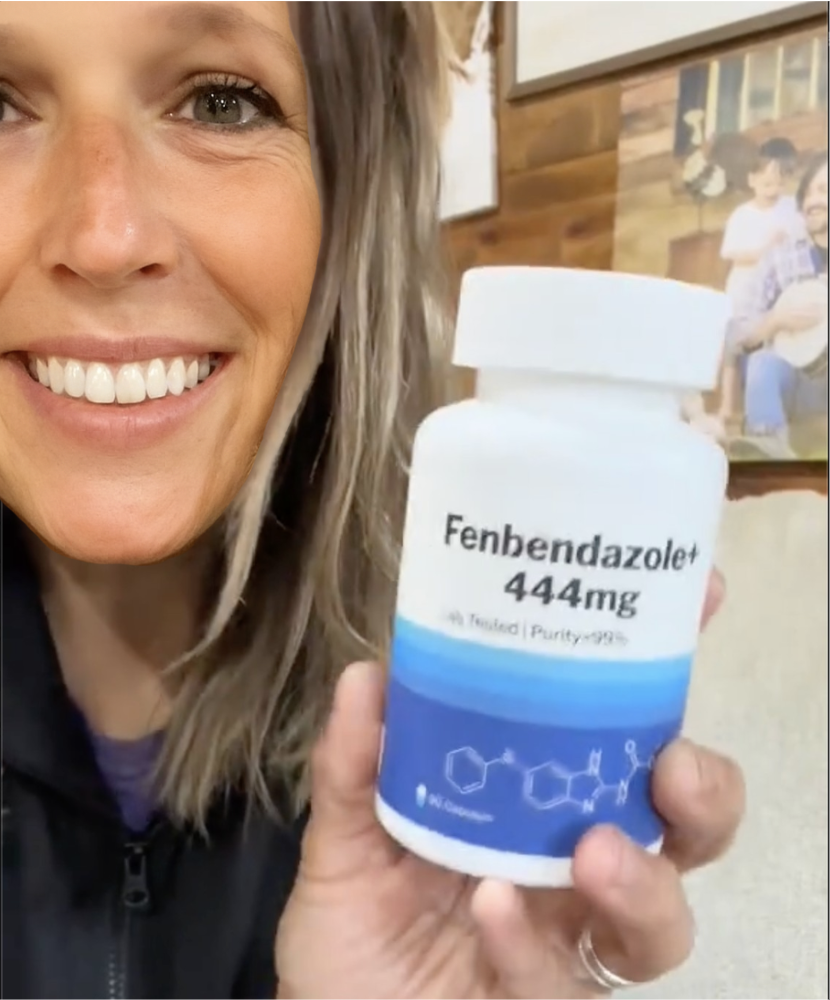 Person holding a bottle labeled 'Fenbendazole+ 444mg' with a chemical structure shown.