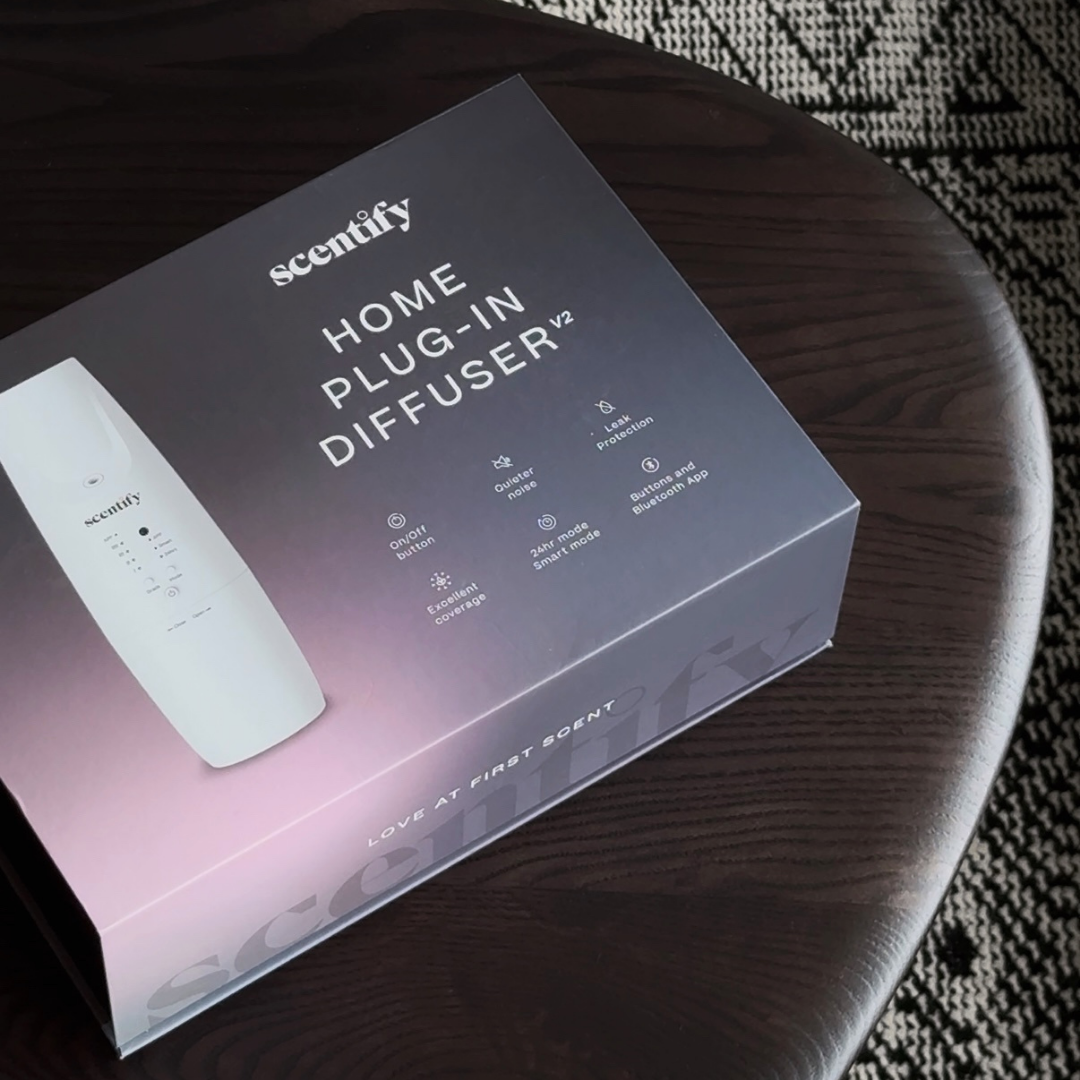 Box of a home plug-in diffuser on a wooden table.