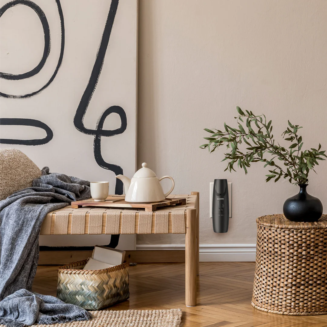 Cozy interior with a tea set on a woven bench, abstract art, and a plant in a wicker basket.
