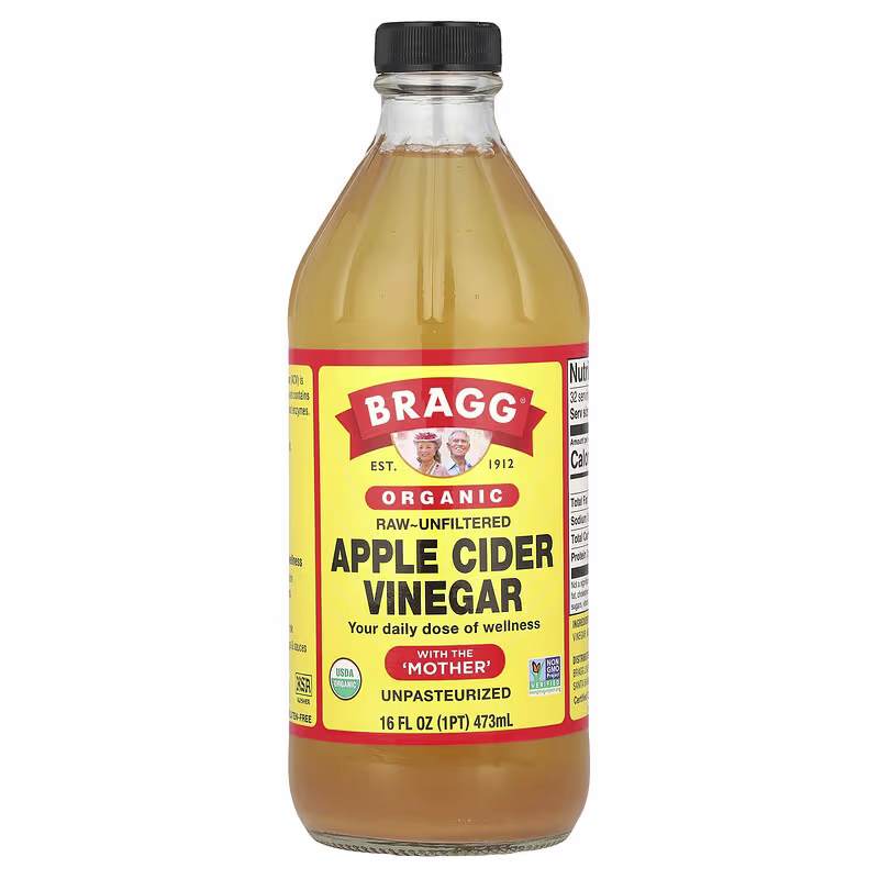 A glass bottle of Bragg Organic Raw-Unfiltered Apple Cider Vinegar against a white background.