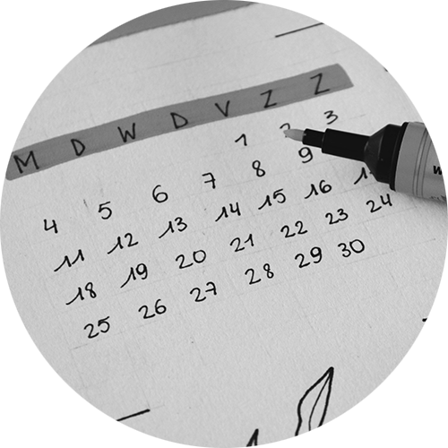 A black-and-white calendar drawing with a marker on a piece of paper.