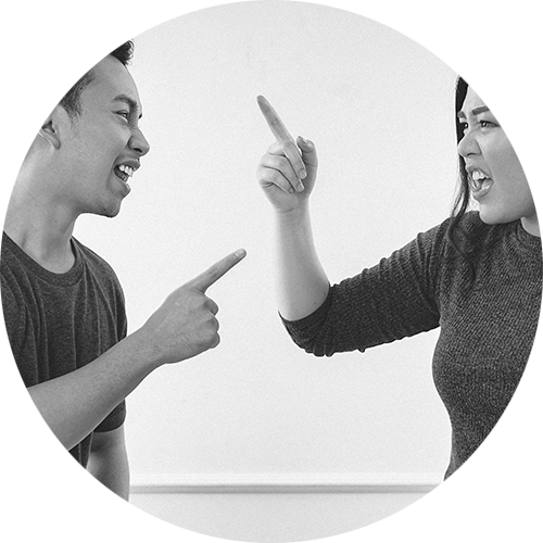 Two people in a heated disagreement, pointing and expressing frustration.