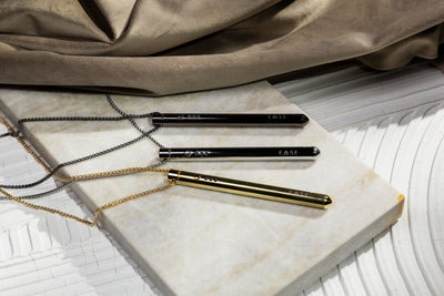 Three stylus pens on a marble surface with fabric background.