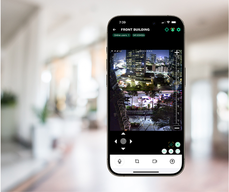 Smartphone displaying security camera footage of a building's exterior at night.