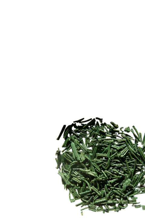 A pile of green spirulina powder on a white background.
