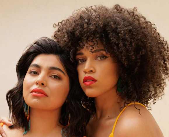 Two women with natural beauty styling representing Nopalera brand aesthetic