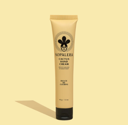 A tube of Nopalera Cactus Hand Cream stands upright against a pale yellow background.