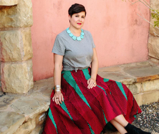 Sandra Velasquez, founder of Nopalera, wearing a colorful skirt outdoors