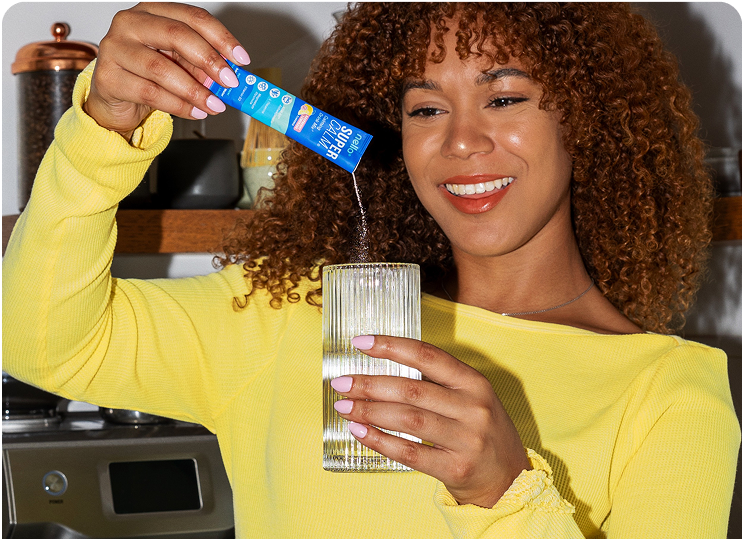 Pouring Oluna Calming Drink Mix stick into water