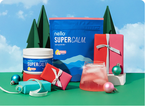 Colorful drink mix packaging with gifts and ornaments in a scenic outdoor setting.