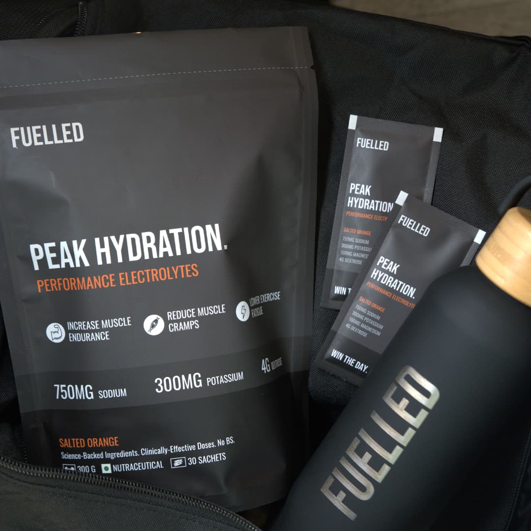 Electrolyte supplement packaging and a black water bottle with 'FUELLED' branding.