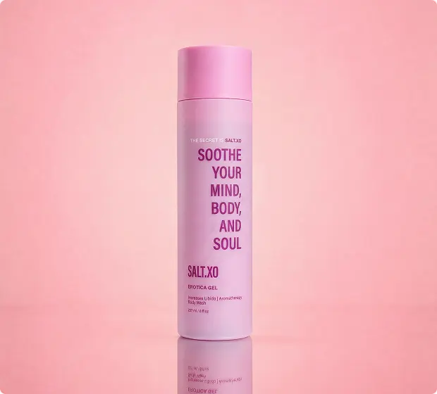 A pink bottle of SALT.XO Soothe Your Mind, Body, And Soul Erotica Gel against a pink background.