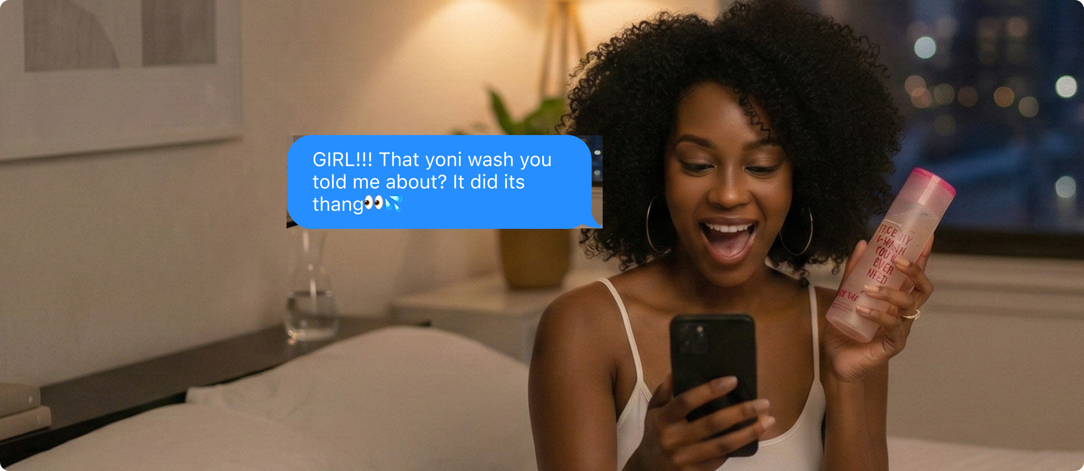 Woman smiling while holding a smartphone and Salt.xo yoni wash bottle, receiving a late-night text from her best friend about the product