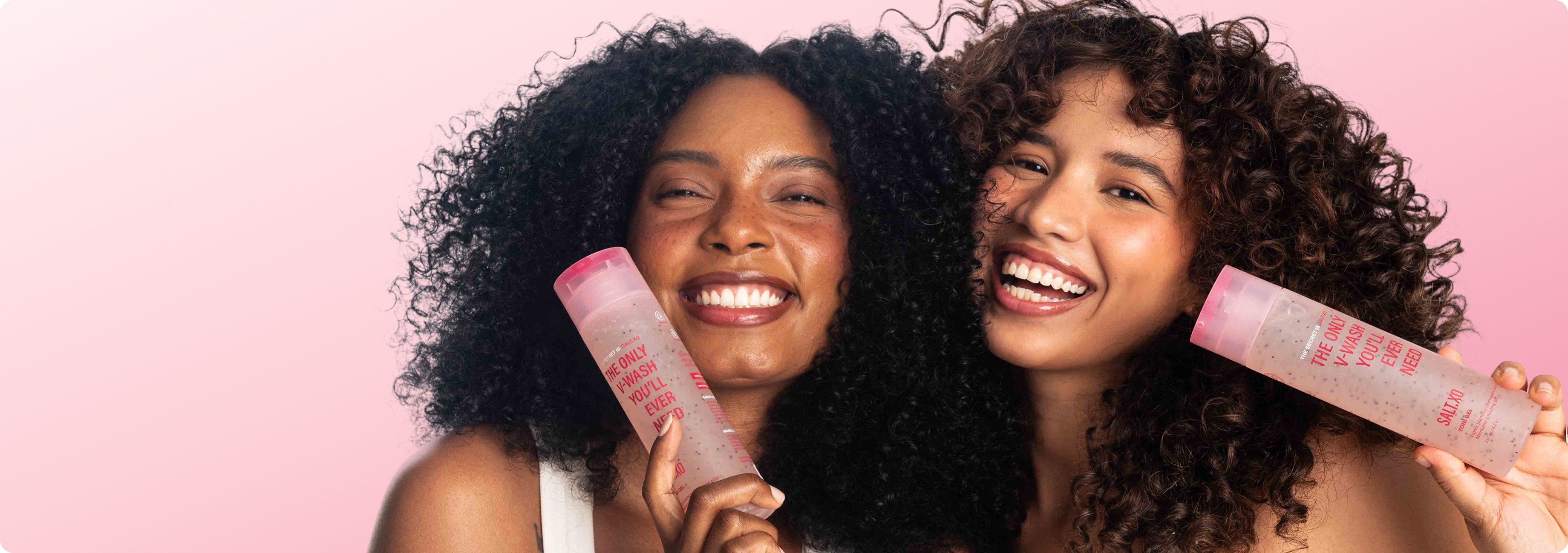 Two diverse women smiling with Salt.XO pH-balanced Yoni Wash bottle - natural intimate vulva cleanser for daily feminine hygiene