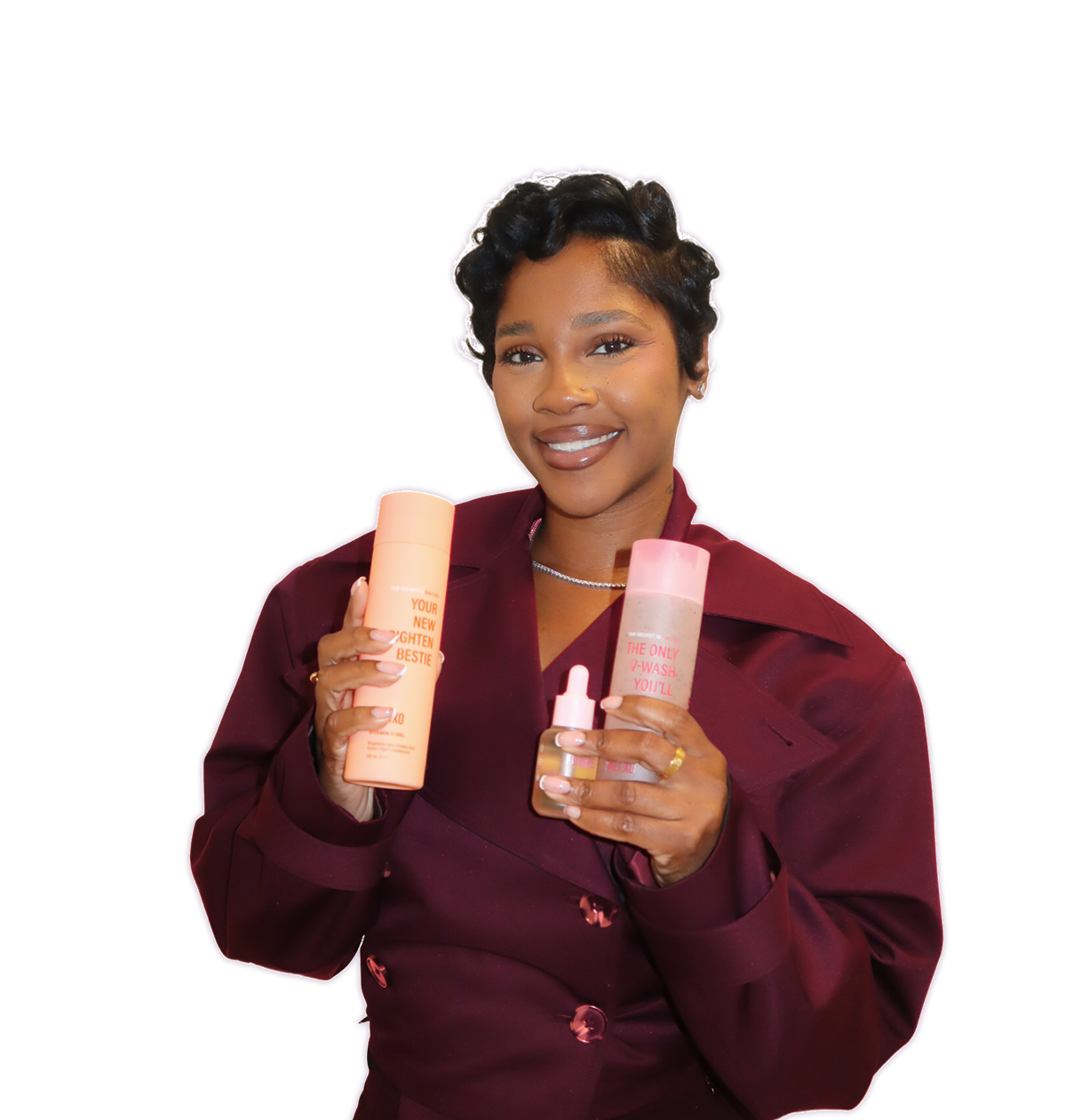 A smiling woman with short, styled hair holds up three different beauty products against a light purple background.