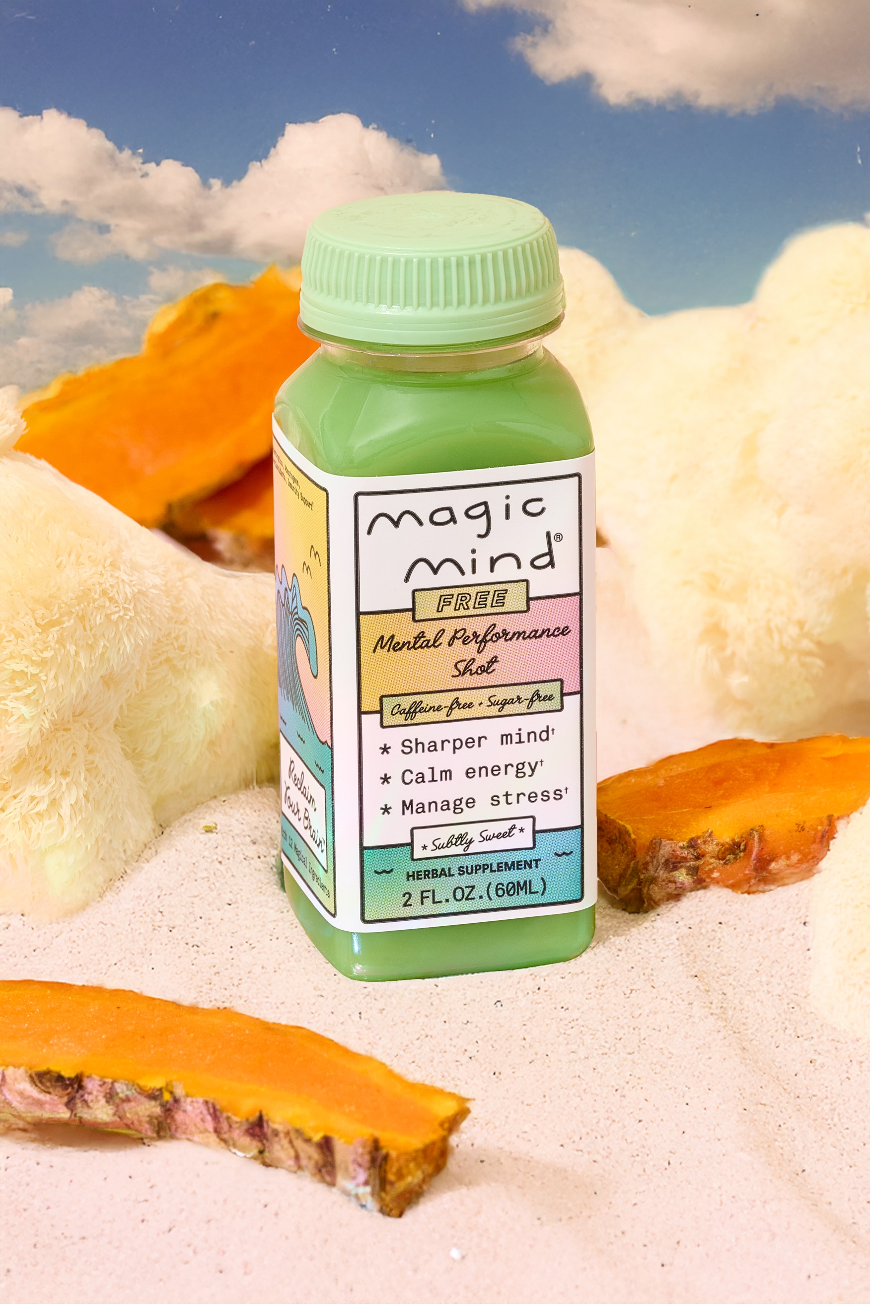 Green bottle labeled 'Magic Mind' on sandy surface with turmeric slices.