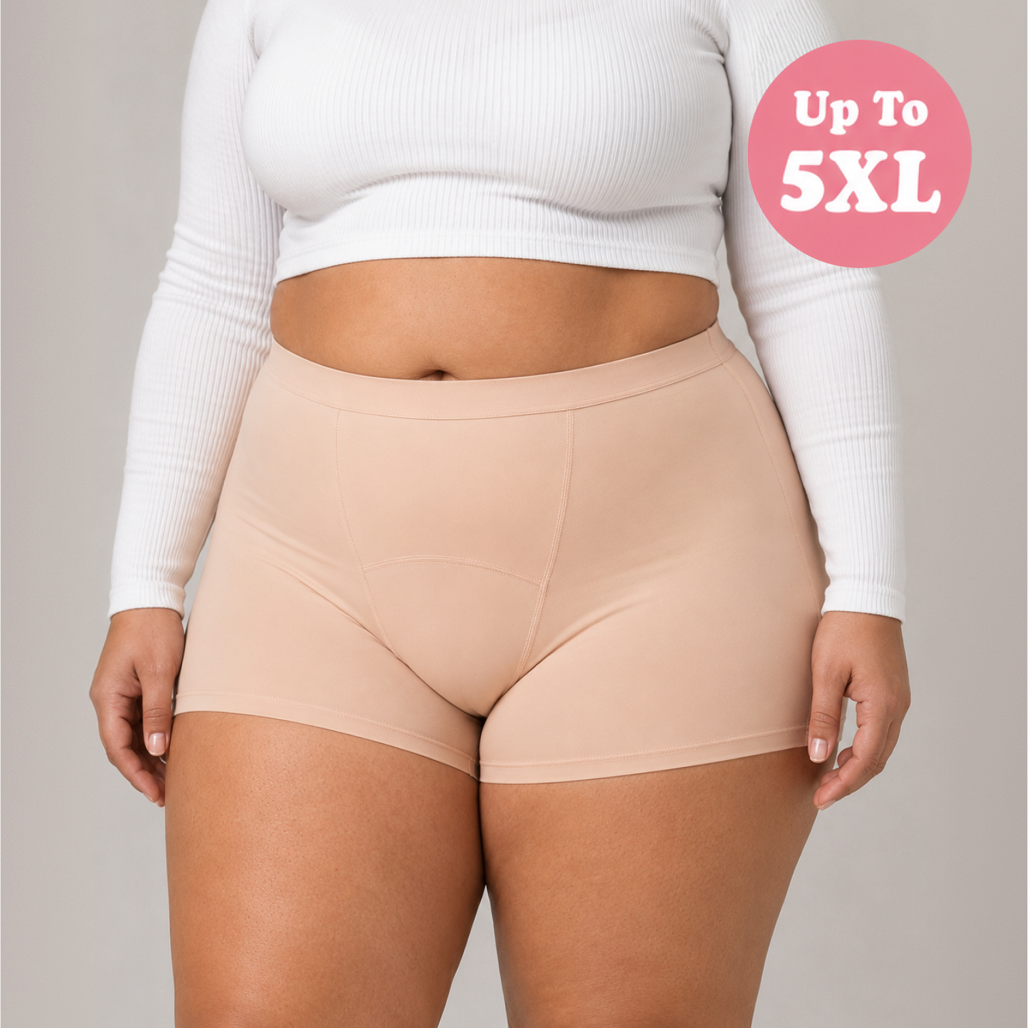 A close-up of a person's midsection wearing a white crop top and tan boy-short underwear.