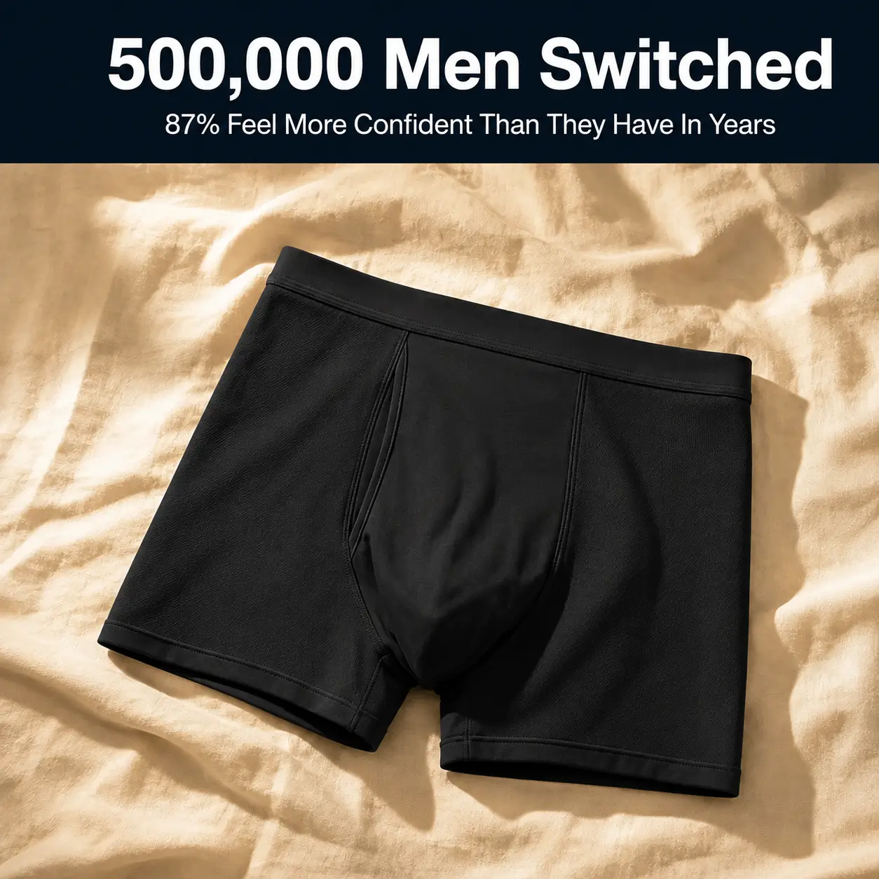 A pair of black men's boxer briefs lying on a rumpled tan sheet with marketing text overlaid.